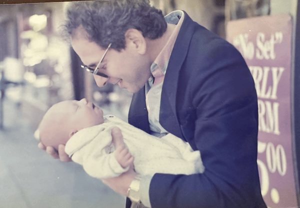 The founder's father holding him as a baby.