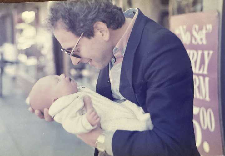 The founder's father holding him as a baby.