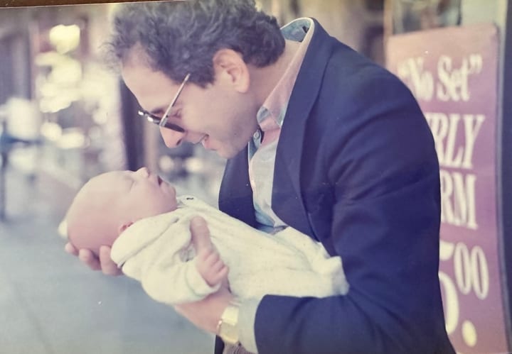 Dad holding a baby on the street