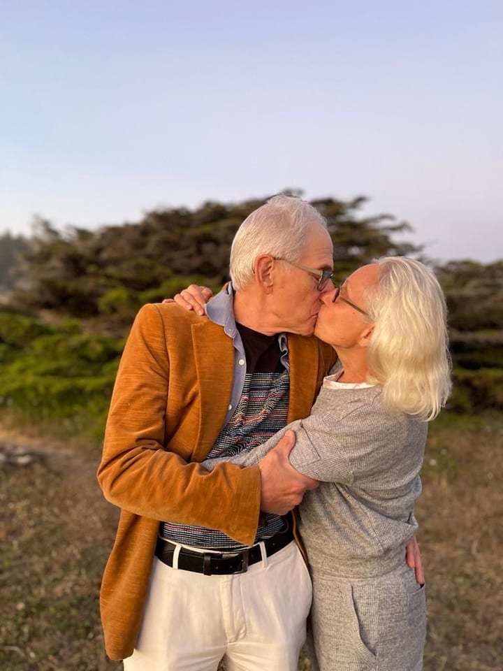 Older couple sharing a kiss outdoors