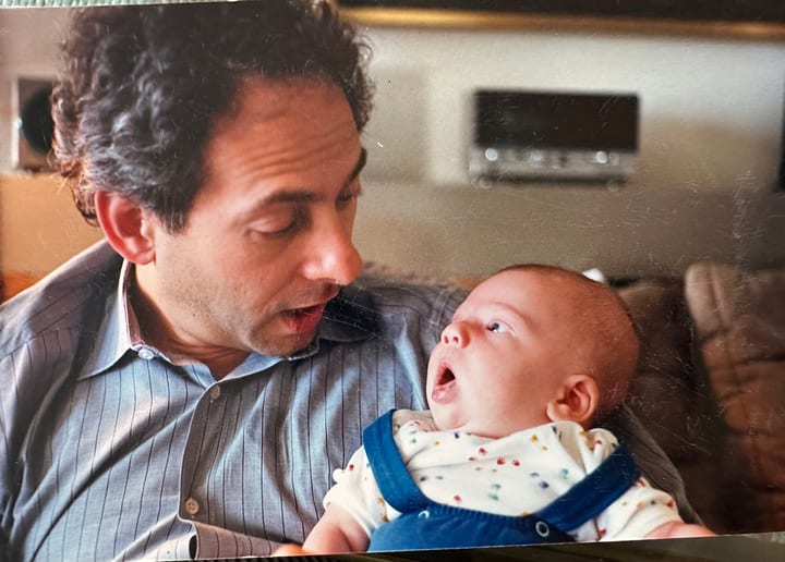 Dad and a newborn, mid-conversation