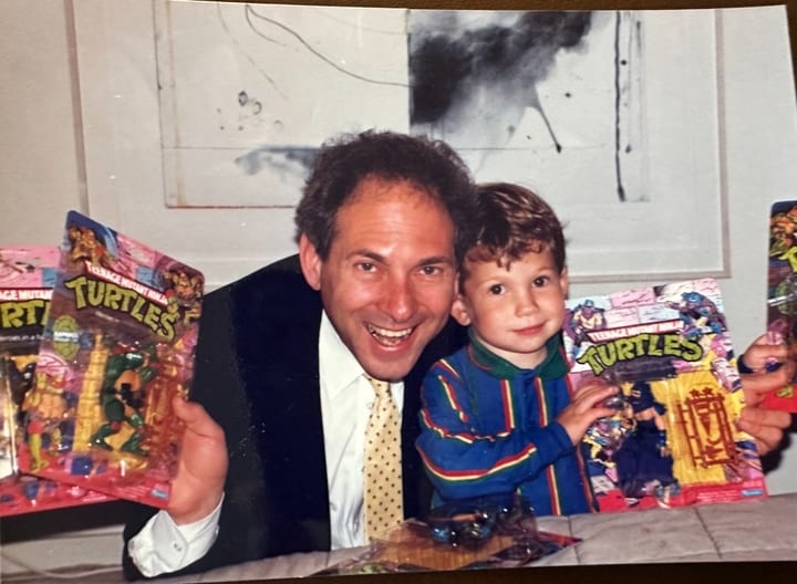 Dad and son with Teenage Mutant Ninja Turtle toys